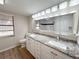 Bright bathroom features double vanity, granite countertop, and decorative tiling at 7026 Whitethorn Ct, Port Richey, FL 34668