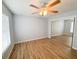 Bedroom with hardwood floors and mirrored closet at 7026 Whitethorn Ct, Port Richey, FL 34668