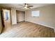 Bedroom featuring wood-look floors, a ceiling fan and neutral paint at 7026 Whitethorn Ct, Port Richey, FL 34668
