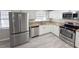 Updated kitchen with granite counters, stainless steel appliances, and white cabinets at 7026 Whitethorn Ct, Port Richey, FL 34668