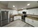 Beautiful kitchen featuring stainless steel appliances, granite countertops, and white cabinetry at 7026 Whitethorn Ct, Port Richey, FL 34668