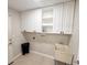 Functional laundry room with ample cabinet space and utility sink at 7026 Whitethorn Ct, Port Richey, FL 34668