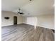 Open-concept living room with vaulted ceiling, laminate floors, and sliding glass door at 7026 Whitethorn Ct, Port Richey, FL 34668