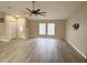Open-concept living room with vaulted ceiling, laminate floors, and natural light at 7026 Whitethorn Ct, Port Richey, FL 34668