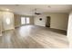 Spacious living room featuring laminate floors, a ceiling fan, and plenty of natural light at 7026 Whitethorn Ct, Port Richey, FL 34668