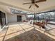 Outdoor patio with a partial enclosure, beautiful plantings, and brick pavers, perfect for relaxing at 7026 Whitethorn Ct, Port Richey, FL 34668