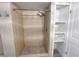 Neutral tiled shower with tiled floor and built in storage at 7026 Whitethorn Ct, Port Richey, FL 34668