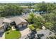 High angle view of the house, with pond and highway beyond a canopy of trees at 7522 Heather Walk Dr, Weeki Wachee, FL 34613