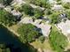 Aerial shot of a house on a pond, surrounded by mature trees and a well-manicured lawn at 7522 Heather Walk Dr, Weeki Wachee, FL 34613