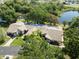 Attractive aerial view of the home with a well-manicured lawn, mature trees, and a paved driveway leading to a two-car garage at 7522 Heather Walk Dr, Weeki Wachee, FL 34613