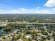 Scenic aerial view of a residential community surrounded by lush greenery and serene ponds, with distant highway access at 7522 Heather Walk Dr, Weeki Wachee, FL 34613