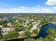 Wide aerial perspective of a community with homes bordering ponds and nestled among lush, mature trees at 7522 Heather Walk Dr, Weeki Wachee, FL 34613