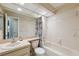 Full bathroom features a combined shower and tub, a single sink, a toilet, and a large mirror at 7522 Heather Walk Dr, Weeki Wachee, FL 34613