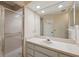 Bathroom featuring a single sink vanity with storage, a toilet, and a glass-enclosed shower at 7522 Heather Walk Dr, Weeki Wachee, FL 34613