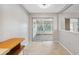 Dining room with sliding doors to sunroom and ceramic tile flooring at 7522 Heather Walk Dr, Weeki Wachee, FL 34613