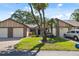 Well-maintained home featuring an American flag, lush lawn, and an inviting entrance at 7522 Heather Walk Dr, Weeki Wachee, FL 34613