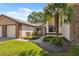 Attractive home exterior with a brick driveway, mature landscaping, and a classic architectural style at 7522 Heather Walk Dr, Weeki Wachee, FL 34613