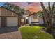 Inviting home exterior with brick accents, a well-kept lawn, and a vibrant sunset backdrop at 7522 Heather Walk Dr, Weeki Wachee, FL 34613