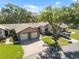 Charming home with a well-maintained lawn, paved driveway, and a two-car garage, nestled among mature trees at 7522 Heather Walk Dr, Weeki Wachee, FL 34613
