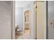 Hallway featuring a vanity, tiled floor, and doorways leading to a closet, bedroom, and bathroom at 7522 Heather Walk Dr, Weeki Wachee, FL 34613
