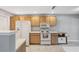 Kitchen features white appliances, light wood cabinets, and lots of counter space at 7522 Heather Walk Dr, Weeki Wachee, FL 34613