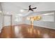 Bright living room with wood floors, vaulted ceilings, and an open concept to the kitchen at 7522 Heather Walk Dr, Weeki Wachee, FL 34613
