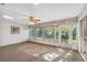 Sunroom with carpet, multiple windows, and ceiling fan at 7522 Heather Walk Dr, Weeki Wachee, FL 34613