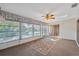 Sunny sunroom featuring an outdoor view and carpet flooring at 7522 Heather Walk Dr, Weeki Wachee, FL 34613