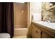 Bathroom featuring a sink, mirror, and toilet with floral wallpaper adding a vintage touch at 846 Oakwood Dr, Tarpon Springs, FL 34689