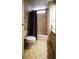 Cozy bathroom featuring a shower/tub combo with a brown curtain and vintage style flooring at 846 Oakwood Dr, Tarpon Springs, FL 34689