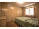 Bedroom with a bed and light-colored wood paneled walls, creating a cozy and classic space at 846 Oakwood Dr, Tarpon Springs, FL 34689