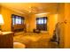 Cozy bedroom with wood-paneled walls, a ceiling fan, and classic furnishings, providing a comfortable retreat at 846 Oakwood Dr, Tarpon Springs, FL 34689