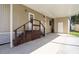 Exterior view of the carport featuring wooden stairs and a storage area at 846 Oakwood Dr, Tarpon Springs, FL 34689