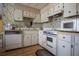Cozy kitchen with white appliances and cabinets at 846 Oakwood Dr, Tarpon Springs, FL 34689