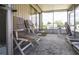 Relax in this enclosed sunroom with ample natural light and comfortable seating at 846 Oakwood Dr, Tarpon Springs, FL 34689