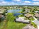 Aerial view of homes with lake views and well-maintained lawns and landscaping at 9032 Cypress Glen Ct, Weeki Wachee, FL 34613