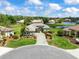 Aerial view showcases this landscaped home, community, and a tranquil lake, creating a picturesque residential setting at 9032 Cypress Glen Ct, Weeki Wachee, FL 34613