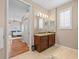 Bathroom with double vanity, granite counters, wood cabinets, and tiled floor at 9032 Cypress Glen Ct, Weeki Wachee, FL 34613