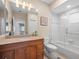 Bathroom featuring granite counters, wood cabinets, and shower and tub combo at 9032 Cypress Glen Ct, Weeki Wachee, FL 34613