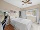 Bedroom with modern decor, hardwood floors, and bright light from the large window at 9032 Cypress Glen Ct, Weeki Wachee, FL 34613