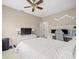 Bedroom with ceiling fan, hardwood floors, and a dedicated work space with dual monitors at 9032 Cypress Glen Ct, Weeki Wachee, FL 34613