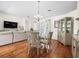 Open-concept dining room connected to living area with a glass table and decorative cabinet at 9032 Cypress Glen Ct, Weeki Wachee, FL 34613
