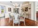 Cozy dining room featuring a glass table, cabinet and stylish chandelier at 9032 Cypress Glen Ct, Weeki Wachee, FL 34613