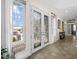 Foyer features decorative glass double doors, tile flooring, and natural light creating a welcoming entrance at 9032 Cypress Glen Ct, Weeki Wachee, FL 34613
