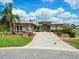 Attractive single-story home with a paver driveway, lush landscaping, and a tiled roof for a stylish curb appeal at 9032 Cypress Glen Ct, Weeki Wachee, FL 34613