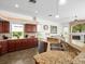 Bright, open kitchen with stainless steel appliances, granite countertops, and a view to the living room at 9032 Cypress Glen Ct, Weeki Wachee, FL 34613