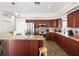 Kitchen boasts updated appliances, granite counters, breakfast bar and wooden cabinetry at 9032 Cypress Glen Ct, Weeki Wachee, FL 34613