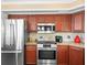 Updated kitchen features stainless steel appliances, granite countertops, and wood cabinets at 9032 Cypress Glen Ct, Weeki Wachee, FL 34613