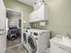 Spacious laundry room with washer, dryer, and ample counter space at 9032 Cypress Glen Ct, Weeki Wachee, FL 34613