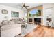 Open living room with fireplace, hardwood floors and comfortable seating at 9032 Cypress Glen Ct, Weeki Wachee, FL 34613